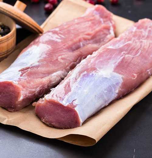 two pieces of raw pork meat on wrapping paper